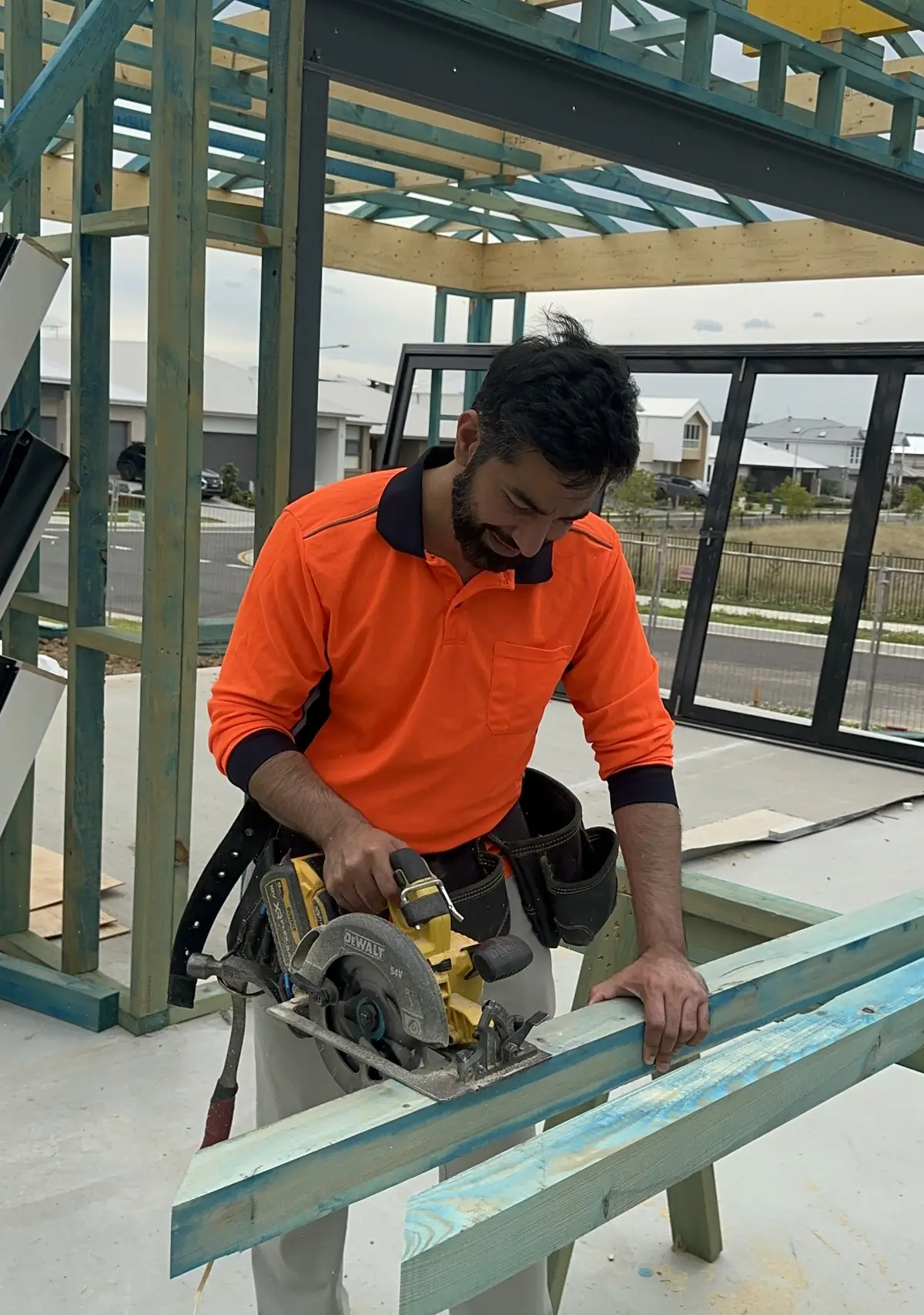 Ali Arshad cutting timber with a circular saw on trestles