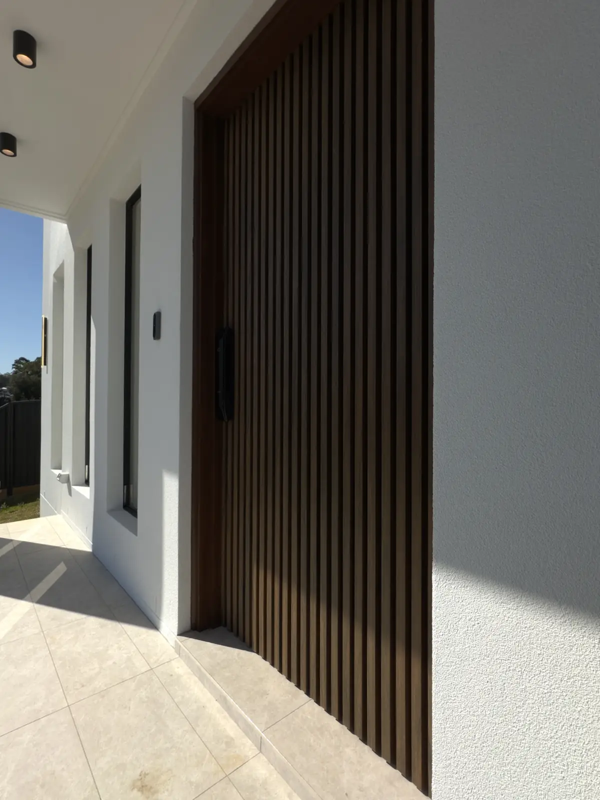 Finished front entry with a timber-battened door