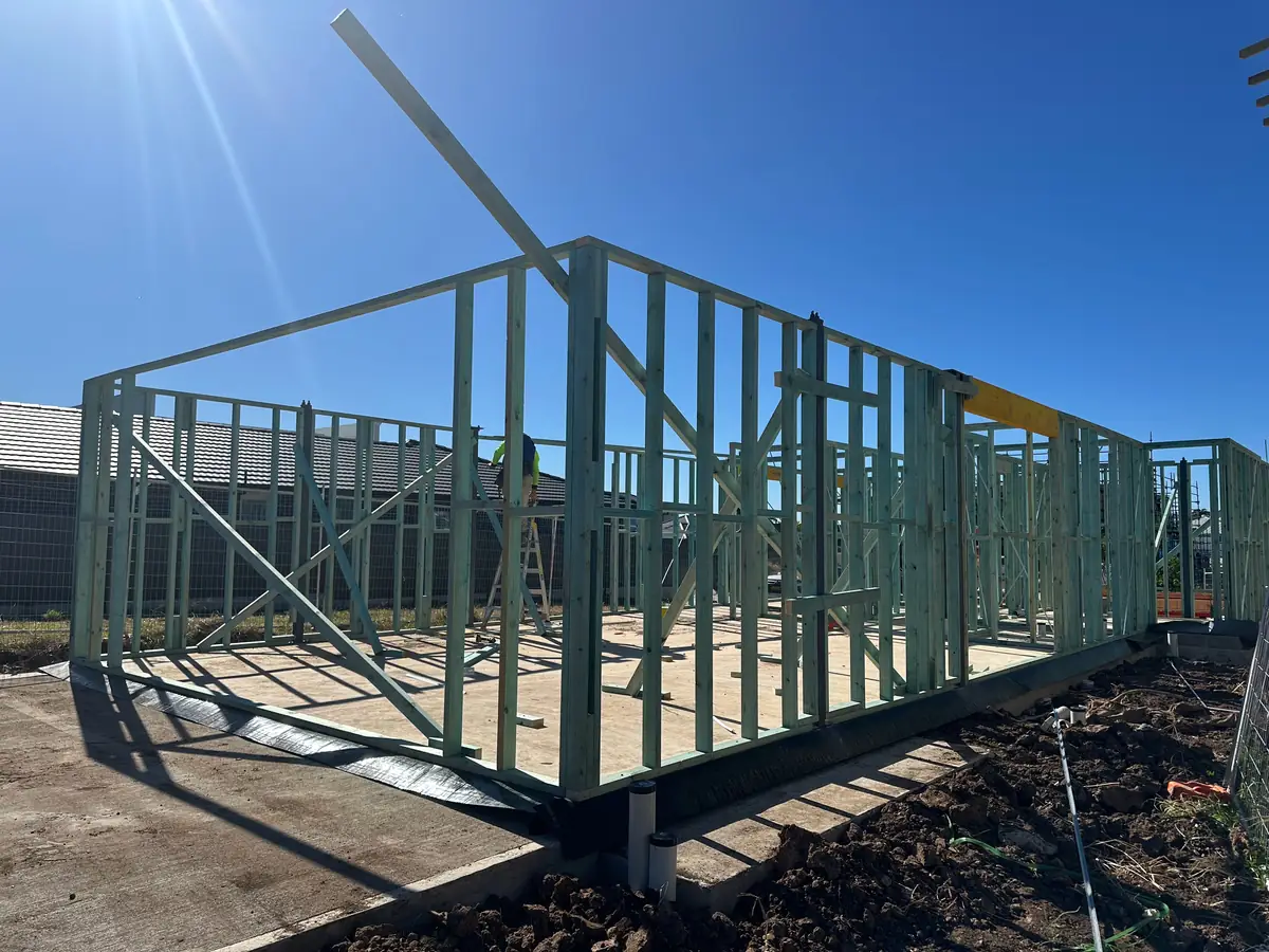 Timber wall frames standing on a new concrete slab